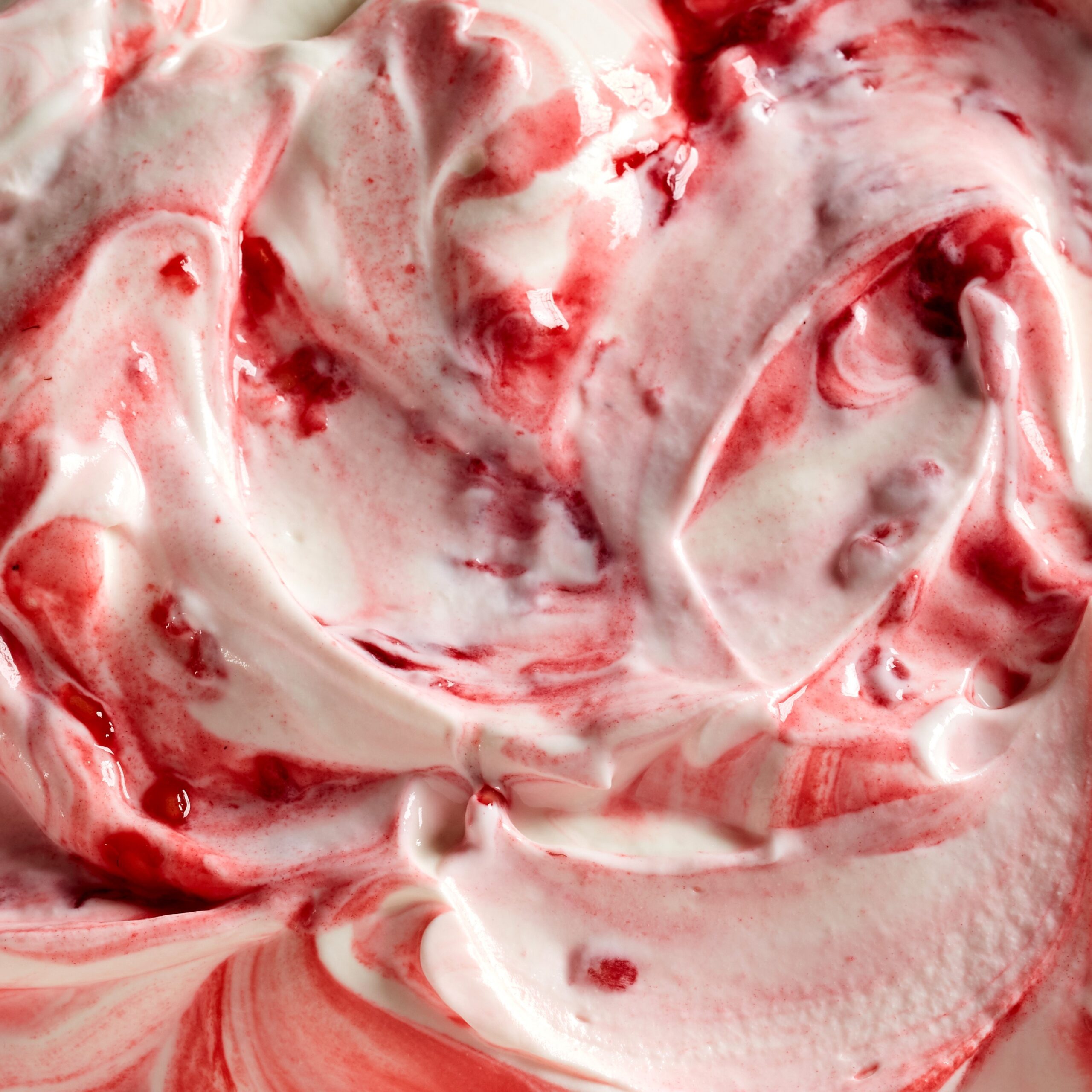 Top view of background of sweet refreshing ice cream with red strawberry jam